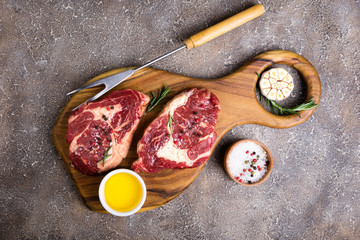 Raw beef steak and ingredients on cutting board. Raw meat. Top view