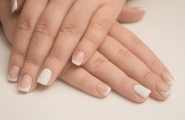Light manicure in light on a white background.