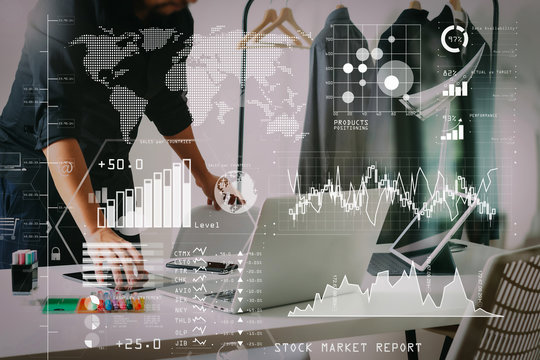 Fashion designer talking mobile phone and using laptop with digital tablet computer in modern studio - Powered by Adobe