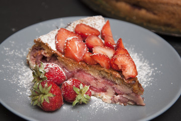 Strawberry Tart Piece. homemade Fruit Berry Cake Tart Pie with Strawberries. Black Board.