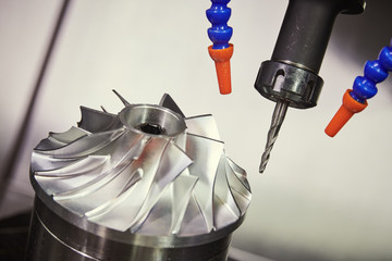Milling metalworking process. CNC machining of turbine impeller by vertical mill