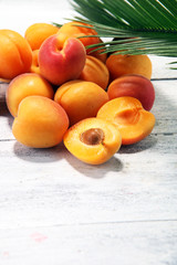 Bunch of fresh apricots on wooden table.
