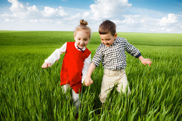 Little children running through the meadow.