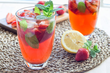 Homemade iced tea with strawberries and mint, horizontal