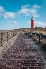 Old lighthouse on the beach of De Cocksdorp on the island of Texel, The Netherlands.