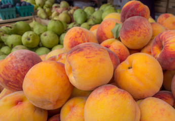 Fresh Farmers Peaches and pears on farm stands. Close up.