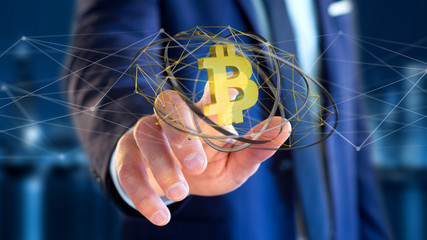 Businessman holding a Bitcoin crypto currency sign flying around a network connection - 3d render