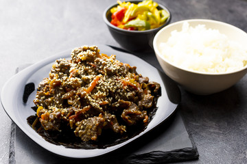 Roasted beef in sauce with spices and sesame seeds in Asian style. Mongolian meat.