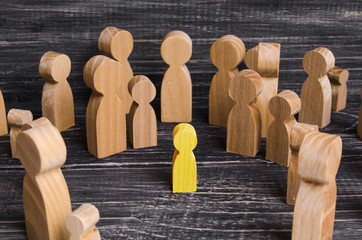 The child was lost in the crowd. A crowd of wooden figures of people surround a lost child. Lost,...