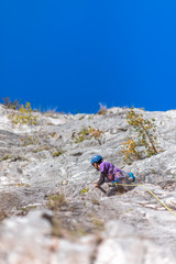 Rock Climber Climbing Up A Cliff