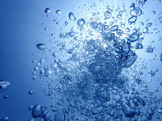 Naklejka na ściany i meble Underwater bubbles with sunlight. Underwater background bubbles.