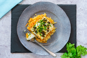 Grilled coriander and lemon cod with carrot pilaf - top view