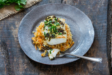 Grilled coriander and lemon cod with carrot pilaf - high angle view