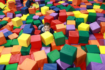 Boy playing at soft cubes