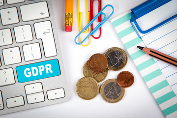 GDPR, General Data Protection Regulation concept. Computer keyboard on a white office desk with various items