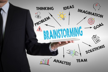 Brainstorming Concept. Chart with keywords and icons. Man holding a tablet computer