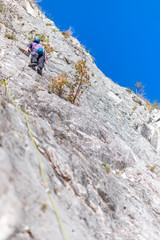 Fototapeta premium Rock climbing on vertical cliff