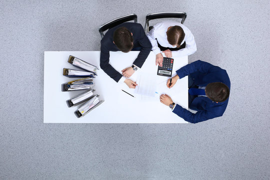 Business people at meeting, view from  above. Bookkeeper or financial inspector  making report, calculating or checking balance