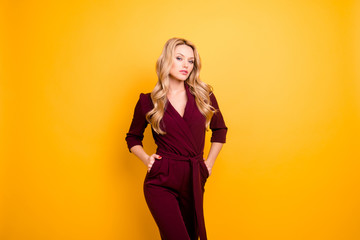 Portrait of stylish stunning lady,  haughty seductive woman holding two hands in pockets looking at...
