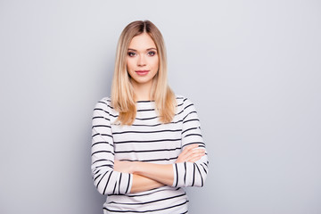 Portrait with copy space, empty place for advertisement of stylish, attractive, charming, nice woman having her arms crossed looking at camera isolated on grey background