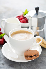 A cup of espresso coffee with macarons
