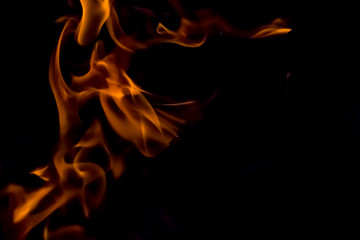A beautiful horizontal texture of a burning fire on a black background with sparks
