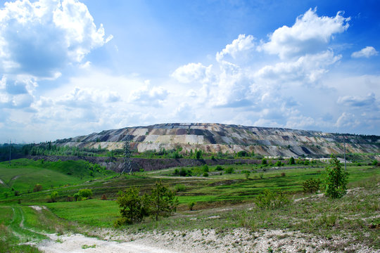 general view of a quarry for the extraction of iron ore by open method against the backdrop of a picturesque and beautiful sky