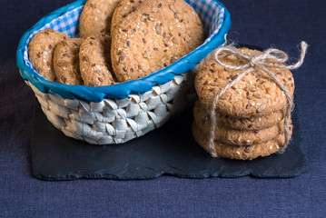 Savory cookies sprinkled with sesame seeds, sunflower on shale board