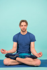 Man meditate on yoga mat. Sportsman relax in lotus pose. Fashion athlete practice yoga in gym. Meditation for body and mind health. Meditation or zen and peace concept