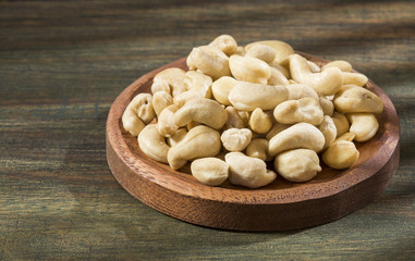 Roasted cashews on wooden background - Anacardium occidentale