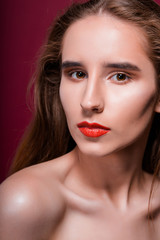 Beauty portrait of young brunette model with clean skin and red lips