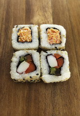 Top View of sushi rolls on a wood background.