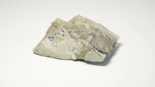 Macro shot of carpathian flysh stone  isolated over white background and spinning around