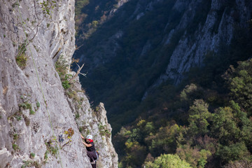 FEMALE  HIKING TO THE MOUNTAIN PEAK