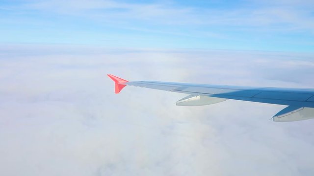 airplane wing flying over cloud scape