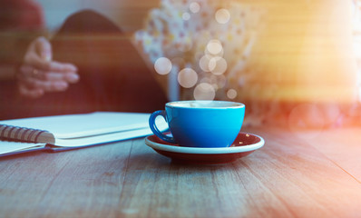 Young woman with cup of coffee at home. Visual effects. Blurred background.Flares, bokeh