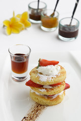 Pancakes with fresh strawberries and maple syrup