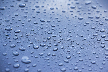 Water drops on a metalic grey car background