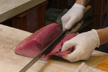Tuna being cut for sushi