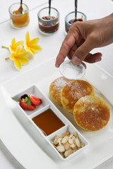 
Pancakes with fresh strawberries and maple syrup served in the restoraunt for breakfast