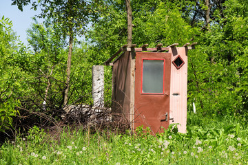 Vintage rustic outdoor toilet in nature