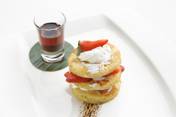 Fototapeta na wymiar Pancakes with fresh strawberries and maple syrup