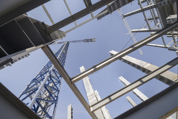 Low-angle shot of a several metal columns and girders of a construction site