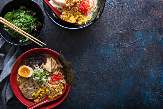 Spicy ramen bowls with noodles, pork and chicken