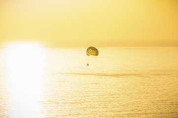 Background colorful sky concept: Dramatic sunset with a boat without clouds. Alanya, Turkey, the Mediterranean Sea