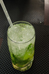 Mojito cocktail with lime and mint in highball glass on a grey stone background Copy space