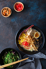 Spicy ramen bowls with noodles, pork and chicken