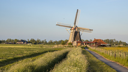 Wooden historic windmill with cycling track