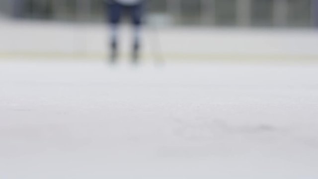Slow Motion Shot of Hockey Player Stopping On Ice