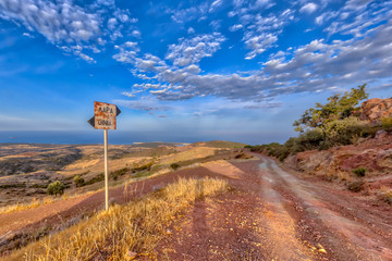 Signposted Mountain road with view over sea on Cyprus Island.
